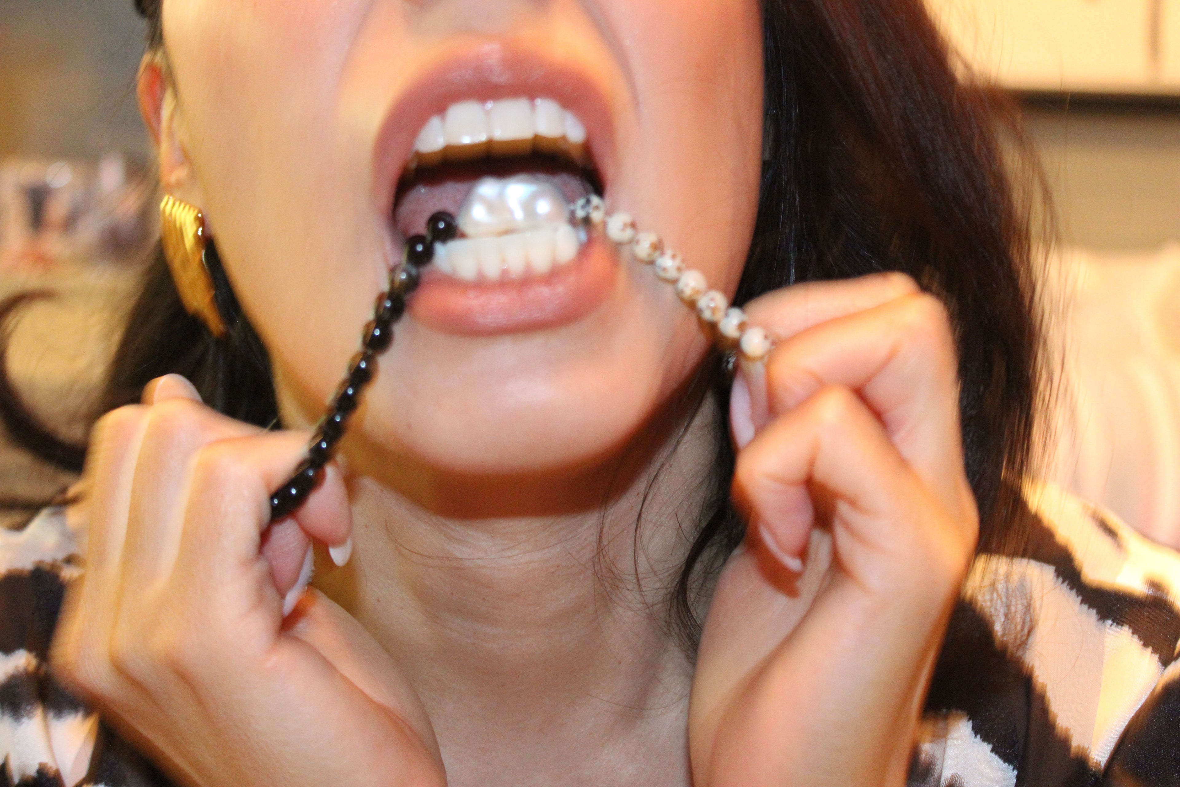 Beaded necklace with black tourmaline, dalmatian jasper, and freshwater pearl centerpiece.