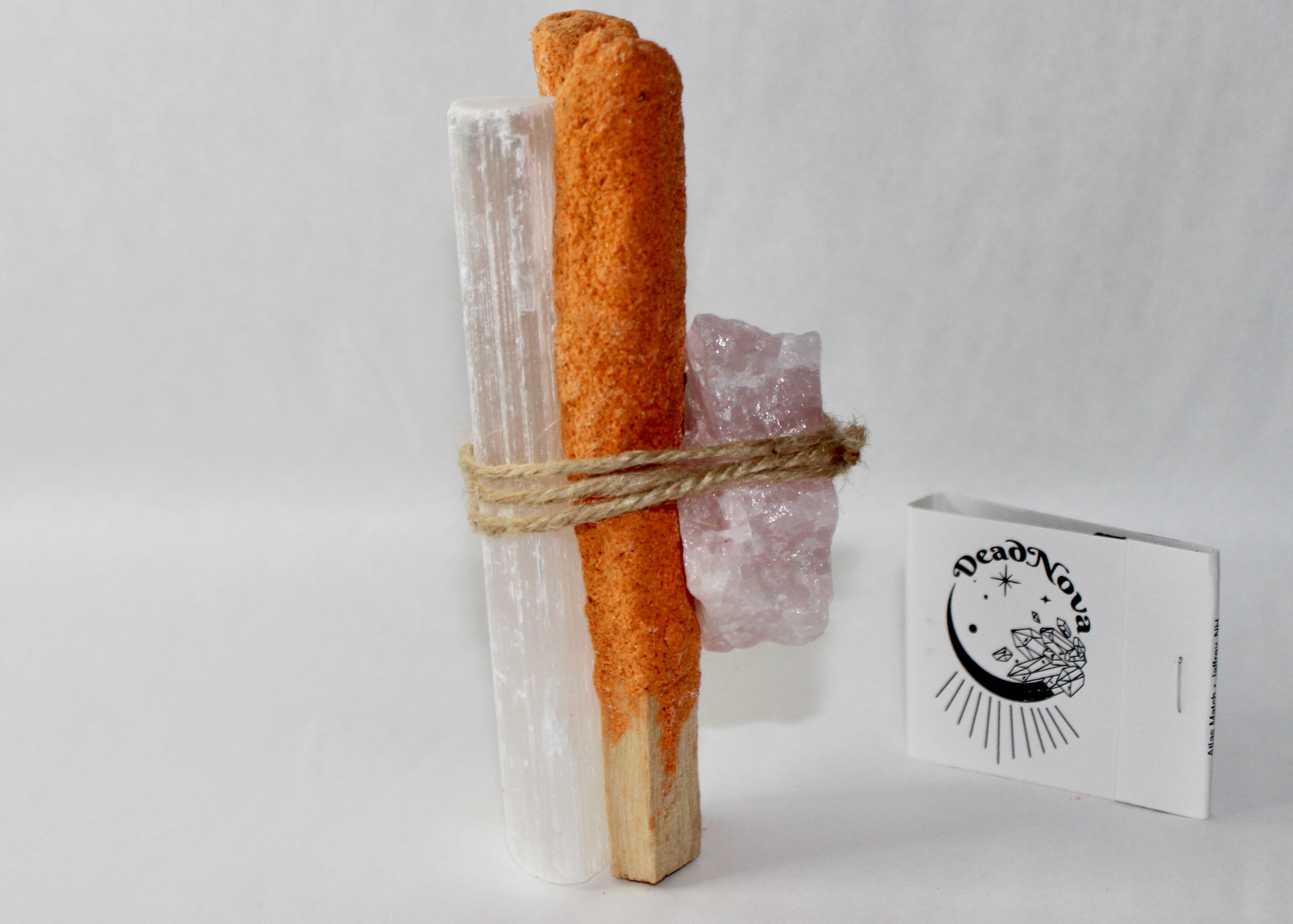 Pumpkin spice palo santo bundle with rose quartz and selenite tied together in twine beside a mini pumpkin, smoke rising  autumn cleansing ritual aesthetic by DeadNova.