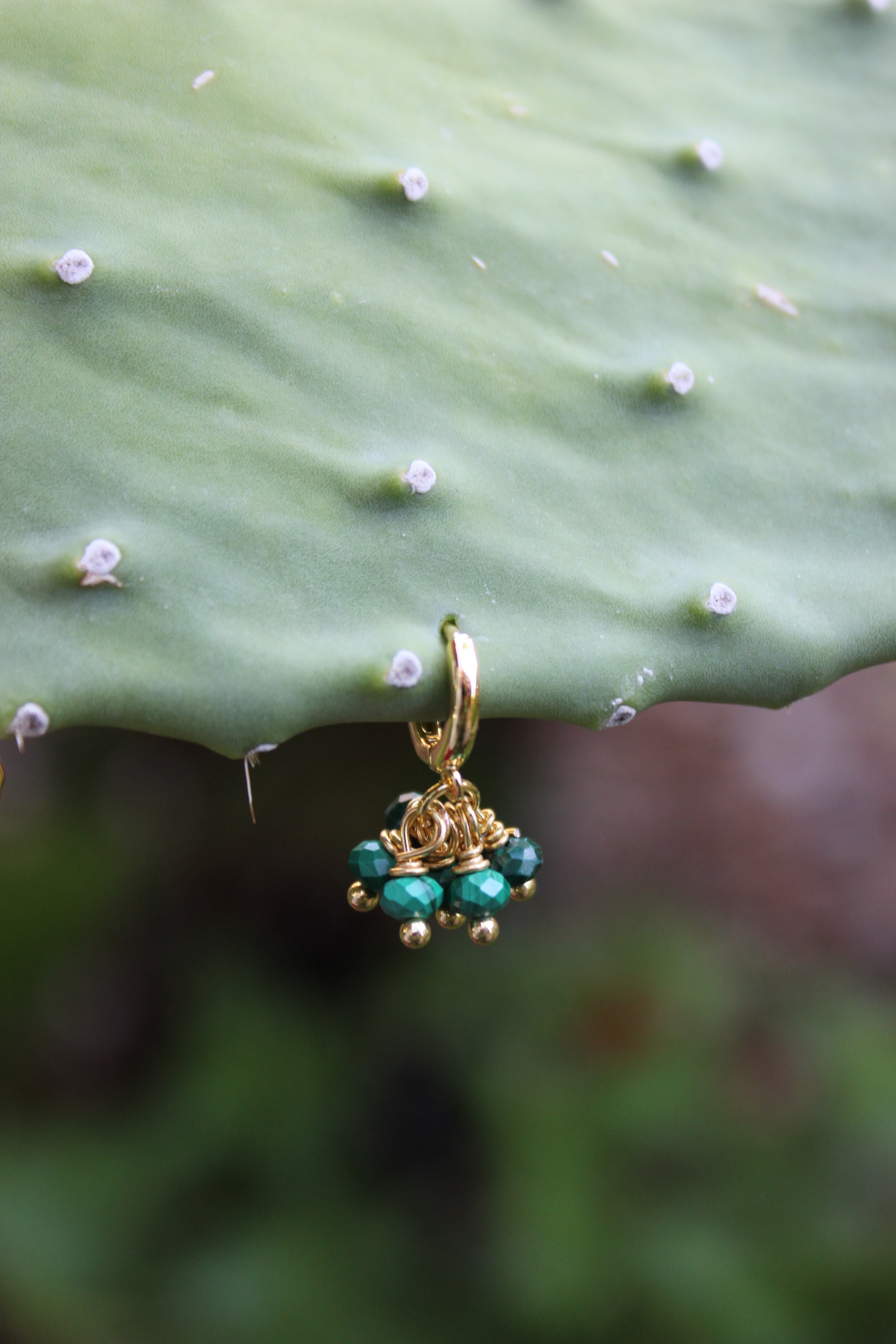 Gold hoop earrings with faceted green malachite beads, non-tarnish hoops for growth and protection.