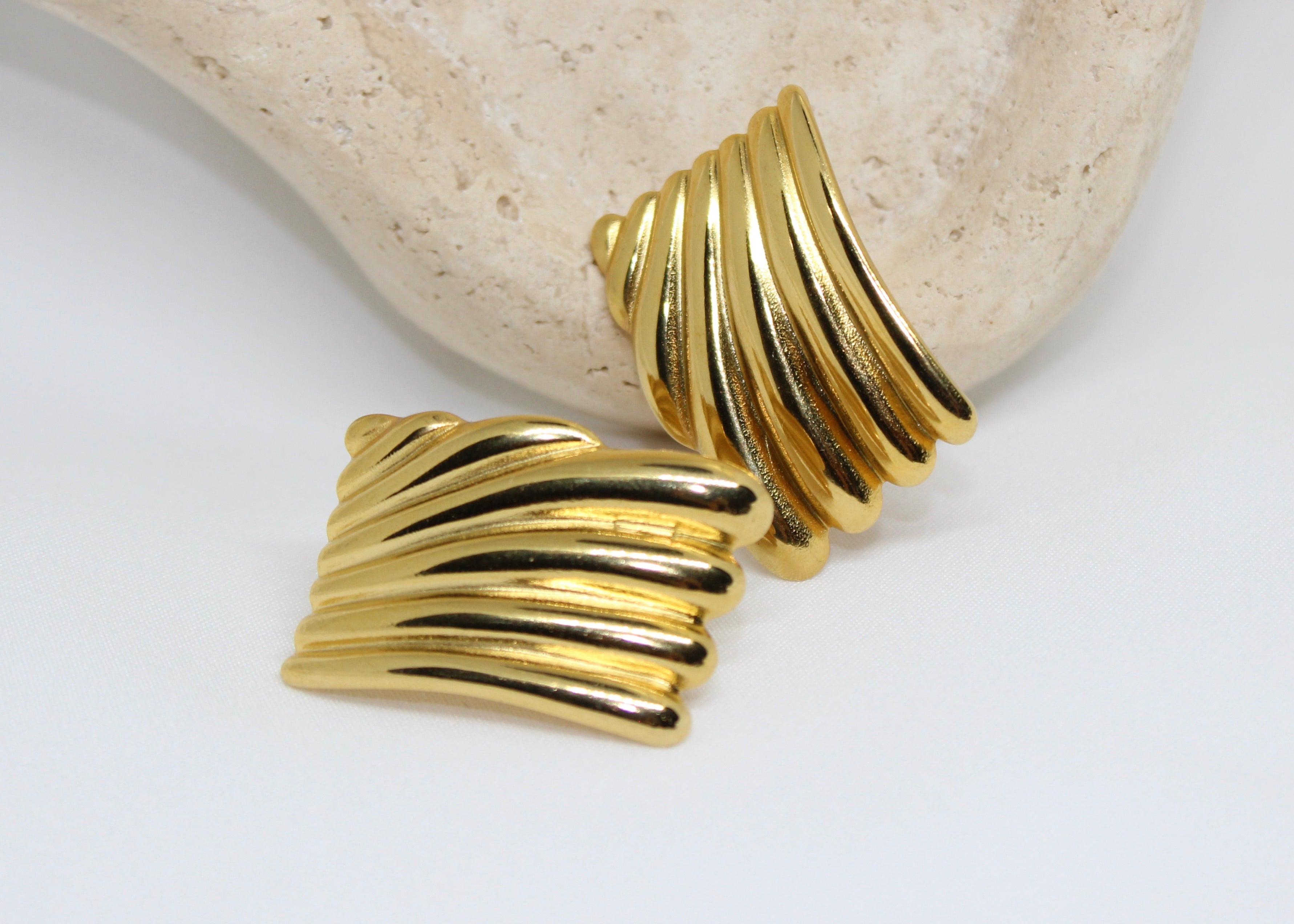 18k gold-filled sculptural drop earrings with twisted ripple design, bold statement studs.