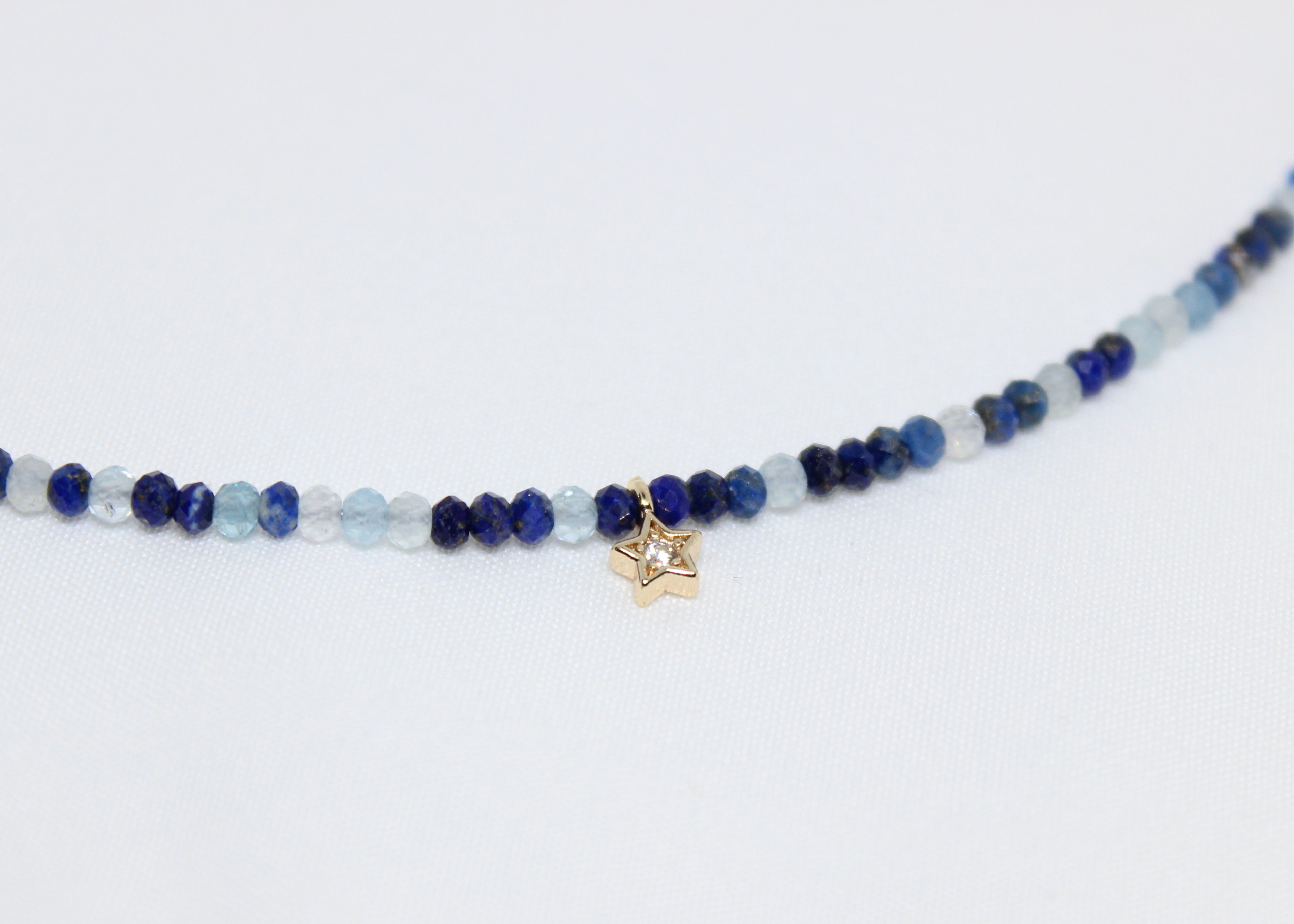 Lapis lazuli and aquamarine necklace with a golden star. Promotes wisdom, peace, and celestial guidance in daily life.