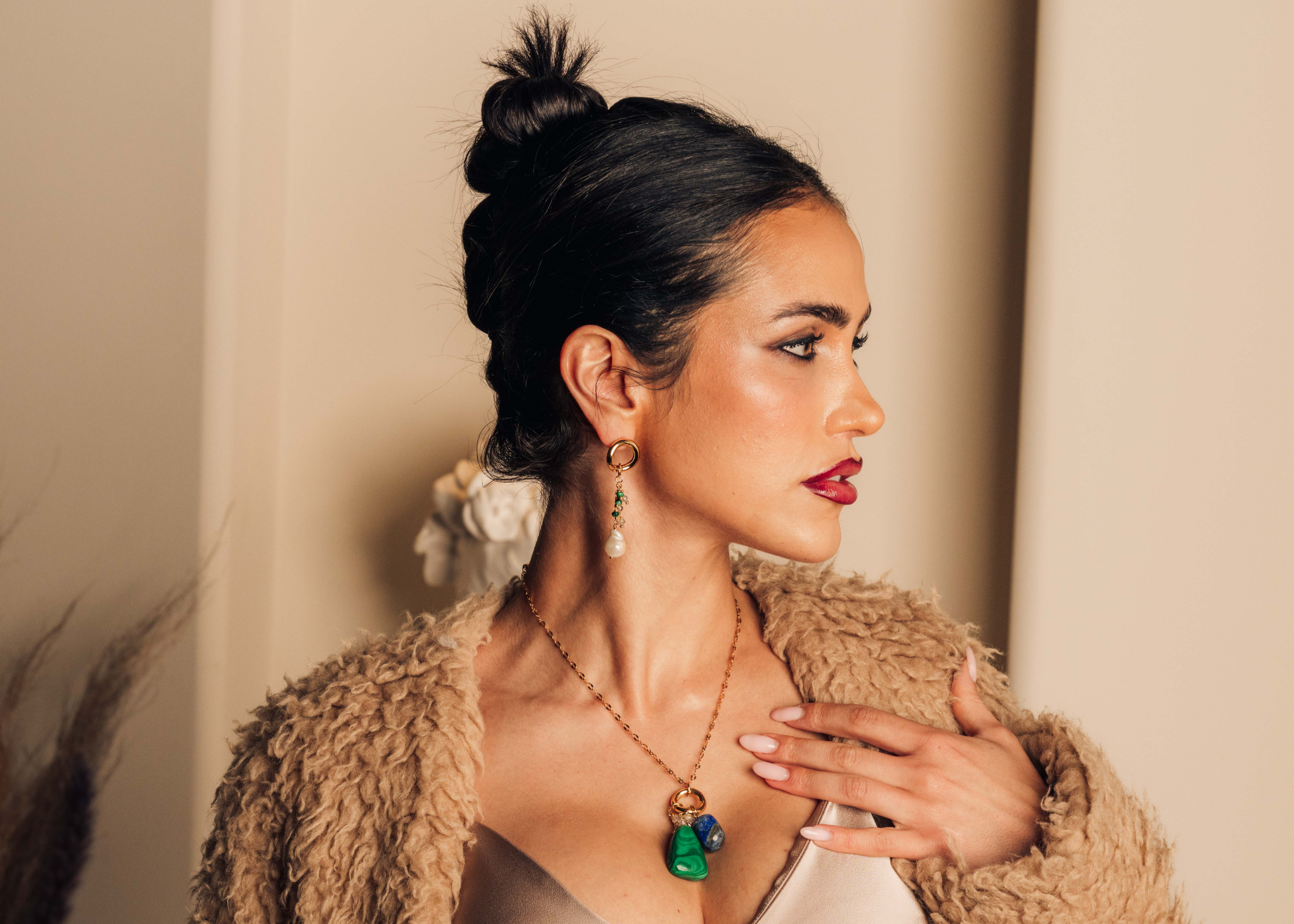 Elegant dangly earrings with clusters of malachite, labradorite beads, and freshwater pearls on gold hoops.