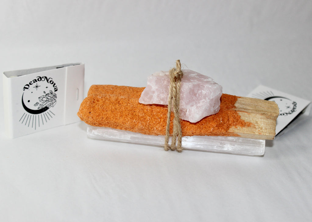 Pumpkin spice palo santo bundle with rose quartz and selenite tied together in twine beside a mini pumpkin, smoke rising  autumn cleansing ritual aesthetic by DeadNova.
