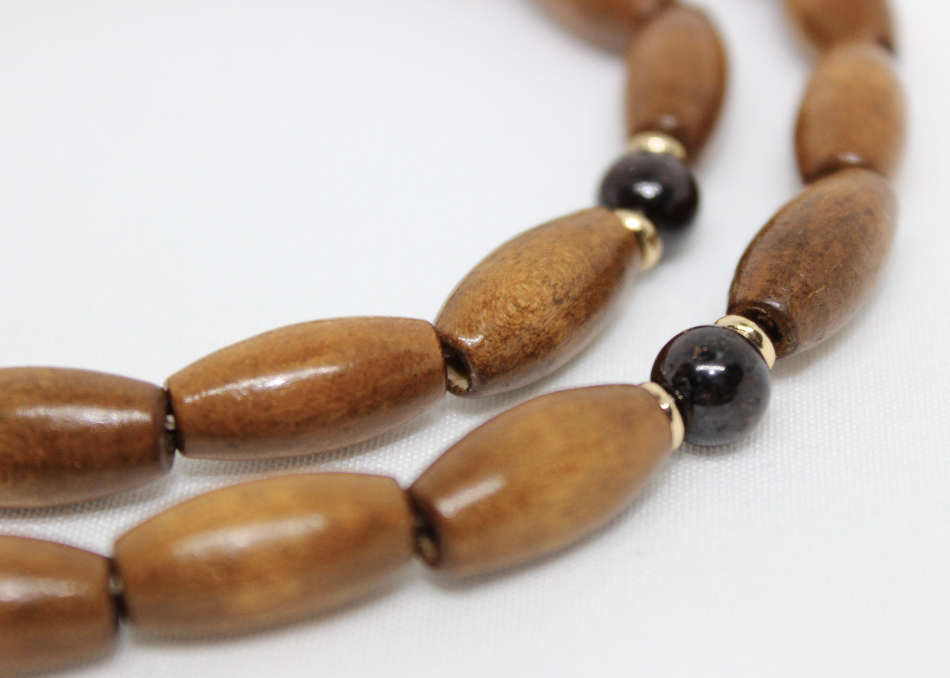 Grounding wood beads with garnet and gold accents. A necklace for strength, balance, and natural elegance in everyday wear.