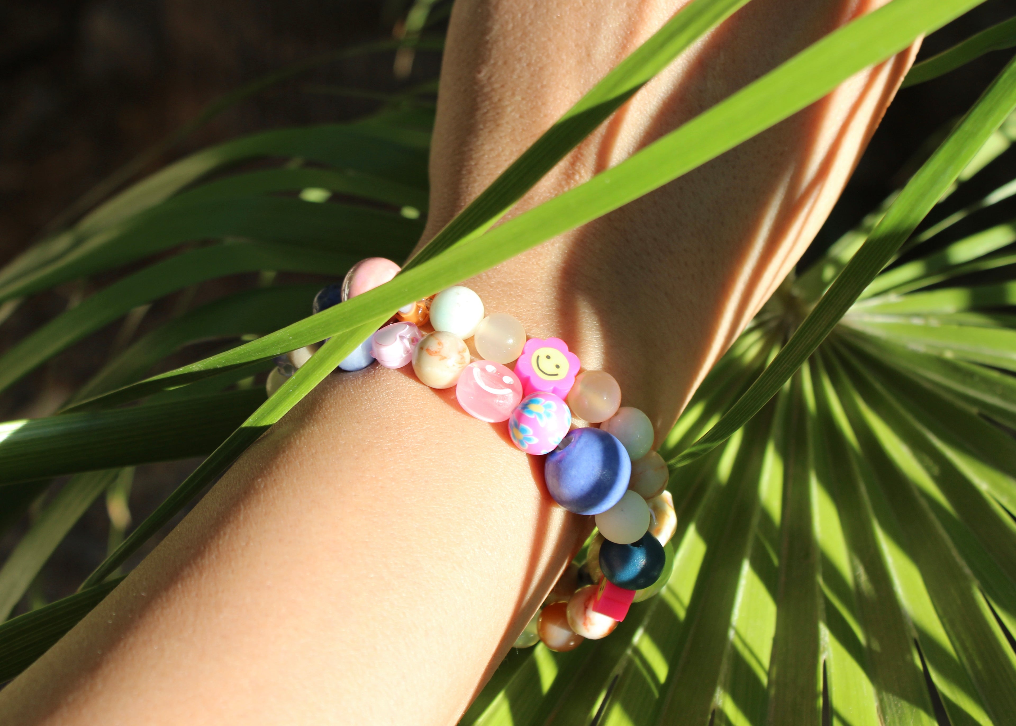 charm bracelet, ceramic charms, natural crystals, smiley faces, wooden beads, stars, flower beads
