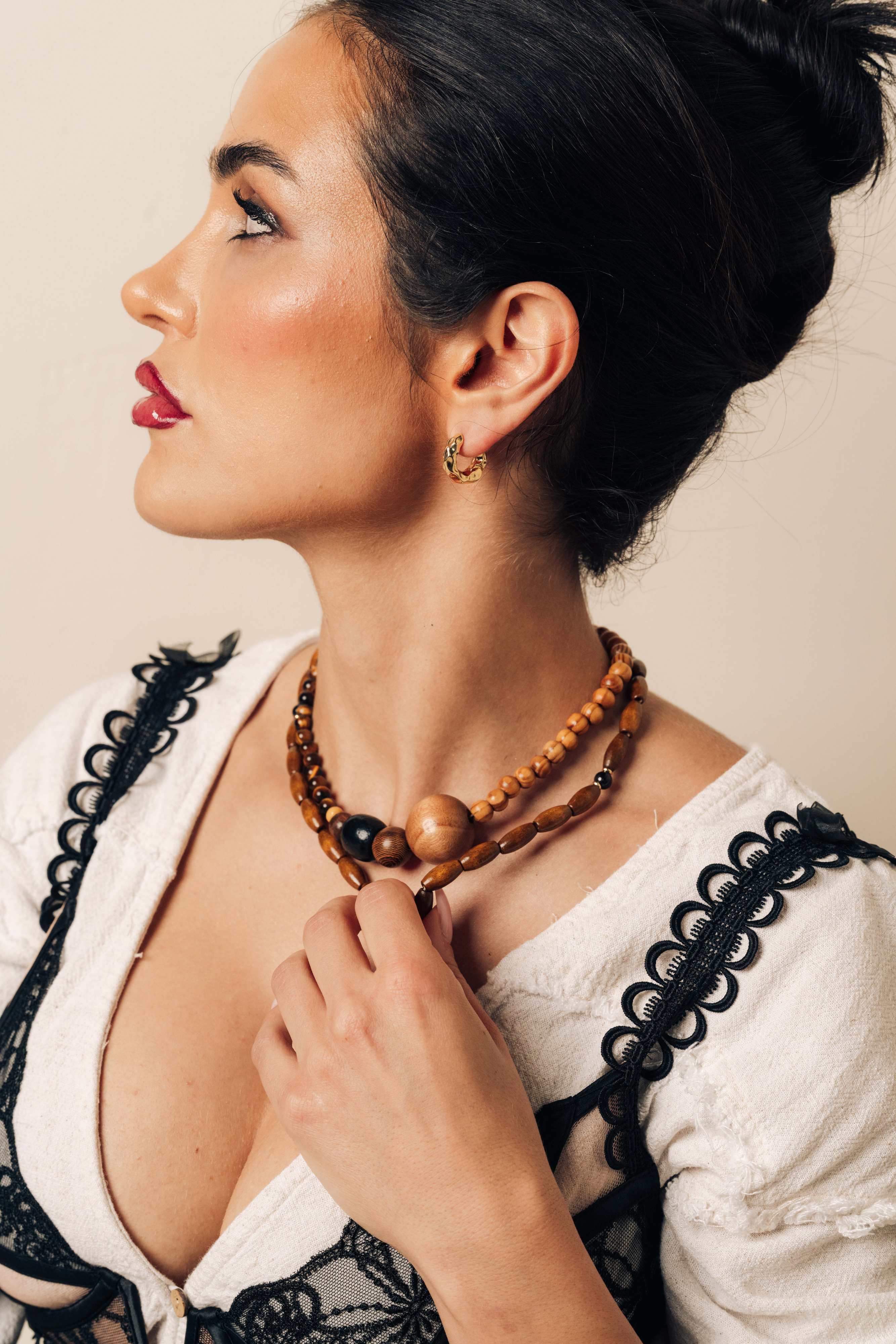 Grounding wood beads with garnet and gold accents. A necklace for strength, balance, and natural elegance in everyday wear.