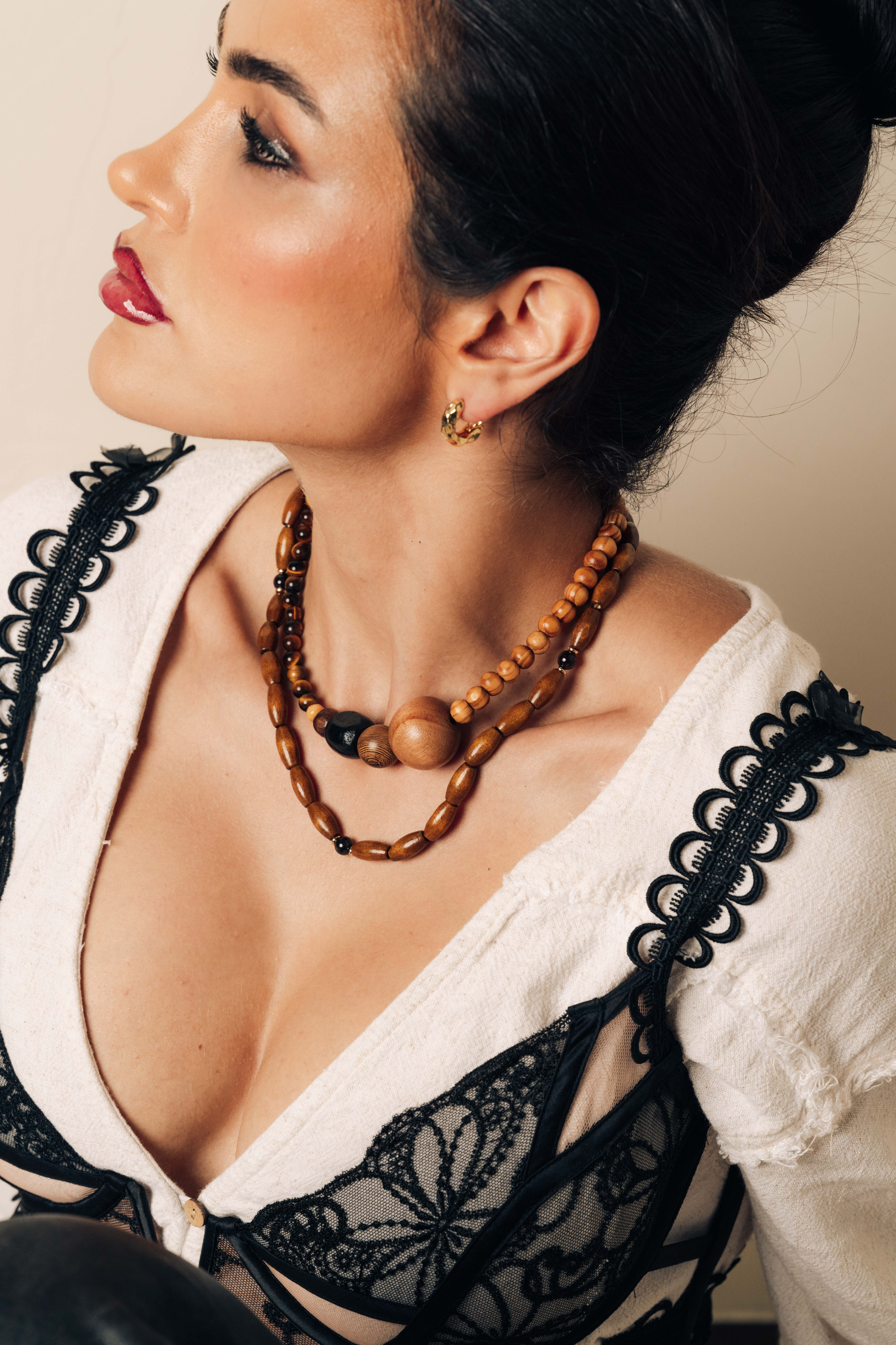 Chunky hammered gold hoop earrings in a sculptural round design, bold non-tarnish hoops for modern style.