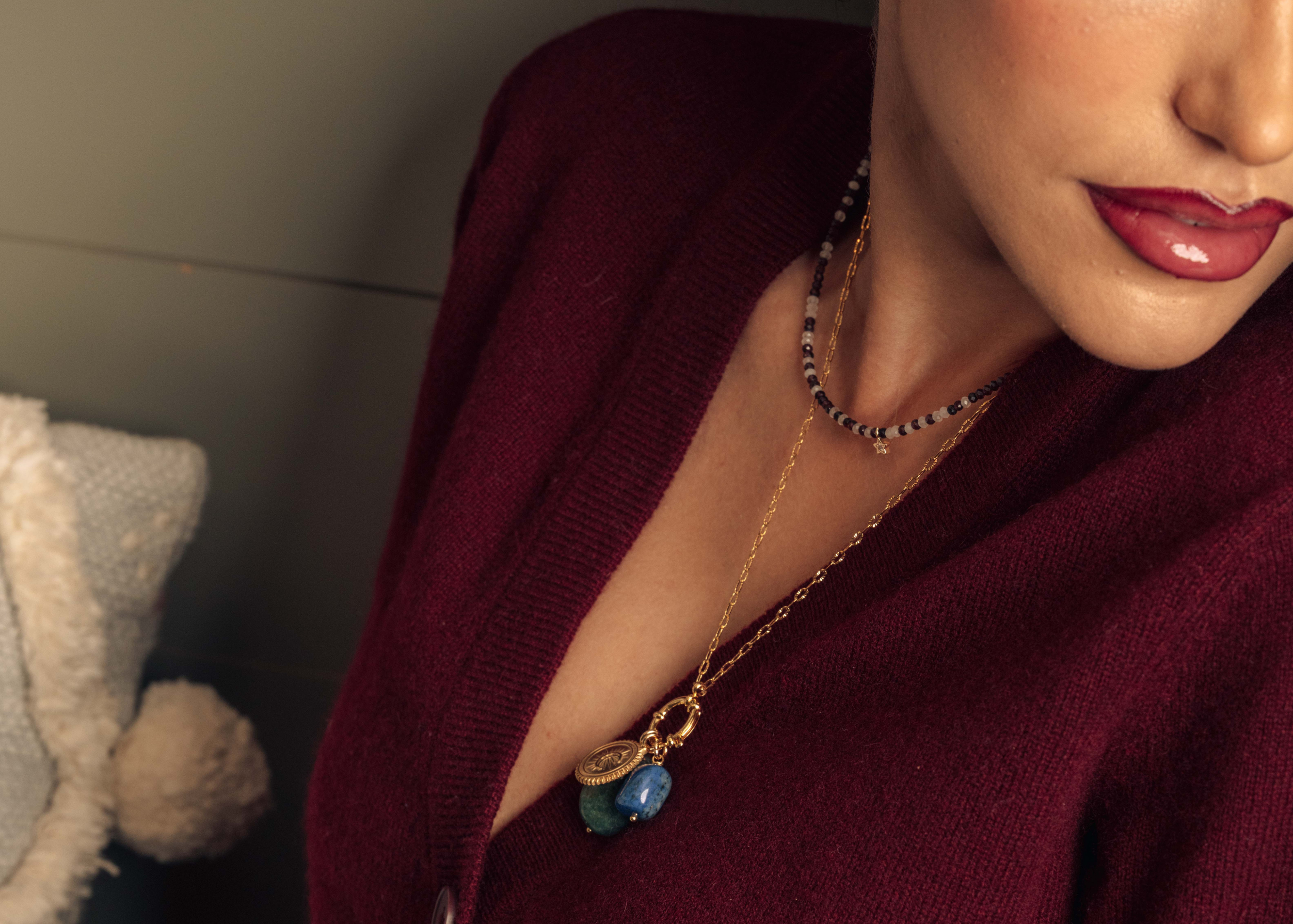 Necklace with garnet and rose quartz beads and a gold star 